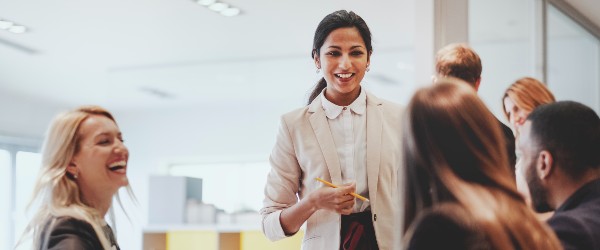 a person smiling with people around the