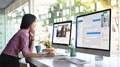 a woman in front of a computer screen