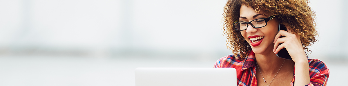 a woman sitting in front of a laptop